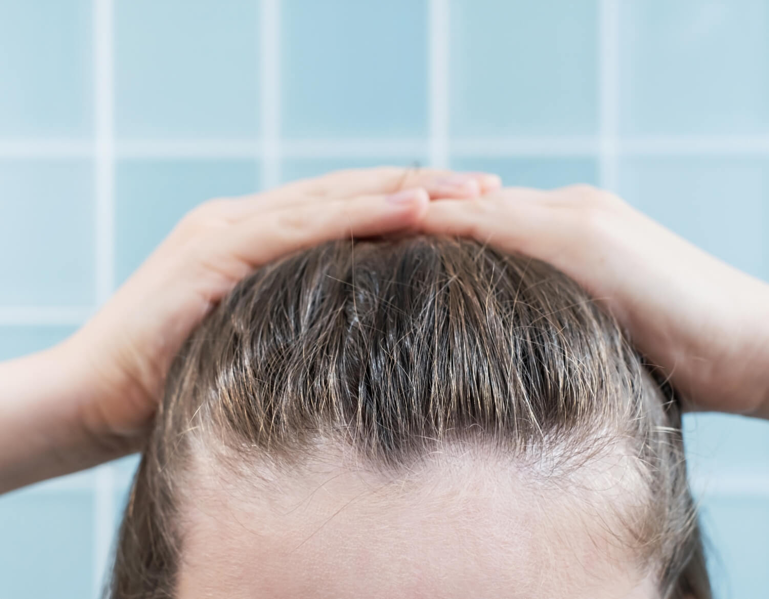 young-woman-touching-her-hair-close-up-on-blue-bac-2023-11-27-05-22-39-utc (2)